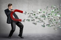 Empresário atrai dinheiro com um grande ímã | Imagem: Tijana Moraca/Shutterstock